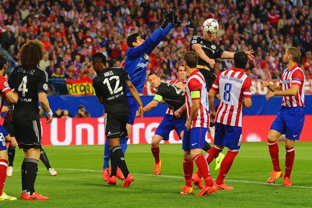 MADRID, SPAIN - APRIL 22: Thibaut Courtois of Club Atletico de Madrid tries to punch clear as Gary Cahill of Chelsea heads the ball during the UEFA Champions League Semi Final first leg match between Club Atletico de Madrid and Chelsea at Vicente Calderon Stadium on April 22, 2014 in Madrid, Spain. (Photo by Mike Hewitt/Getty Images) MADRID, SPAIN - APRIL 22: Thibaut Courtois of Club Atletico de Madrid tries to punch clear as Gary Cahill of Chelsea heads the ball during the UEFA Champions League Semi Final first leg match between Club Atletico de Madrid and Chelsea at Vicente Calderon Stadium on April 22, 2014 in Madrid, Spain. (Photo by Mike Hewitt/Getty Images)