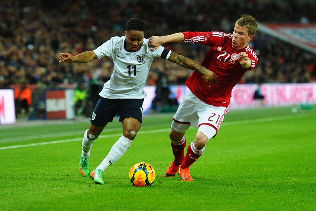 LONDON, ENGLAND - MARCH 05:  Raheem Sterling of England takes on Jesper Juelsgard of Denmark during the International Friendly match between England and Denmark at Wembley Stadium on March 5, 2014 in London, England.  (Photo by Laurence Griffiths/Getty Images)