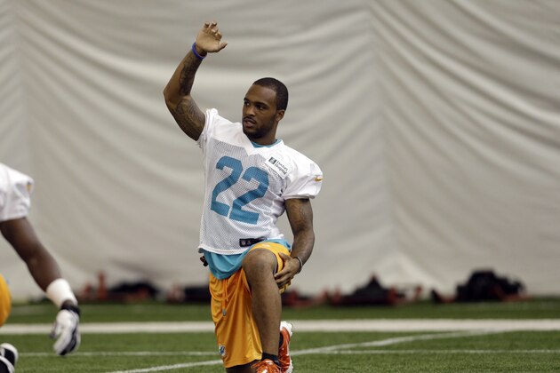 Miami Dolphins cornerback Jamar Taylor (22) stretches during an NFL football practice, Monday, July 22, 2013, in Davie, Fla. (AP Photo/Lynne Sladky)