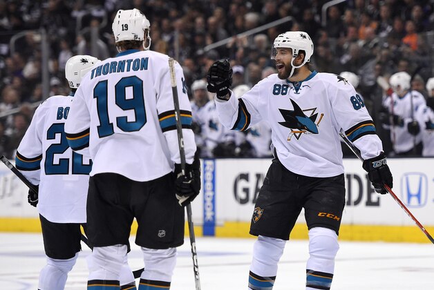 San Jose Sharks right wing Brent Burns, right, celebrates his goal with teammates defenseman Dan Boyle, left, and center Joe Thornton during the first period in Game 3 of an NHL hockey first-round playoff series , Tuesday, April 22, 2014, in Los Angeles. (AP Photo/Mark J. Terrill)