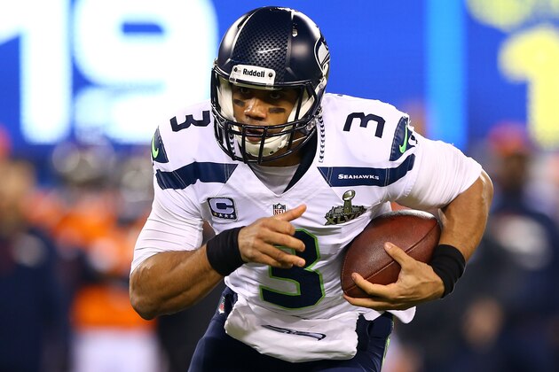 EAST RUTHERFORD, NJ - FEBRUARY 02:  Quarterback Russell Wilson #3 of the Seattle Seahawks runs the ball against the Denver Broncos during Super Bowl XLVIII at MetLife Stadium on February 2, 2014 in East Rutherford, New Jersey.  (Photo by Elsa/Getty Images)