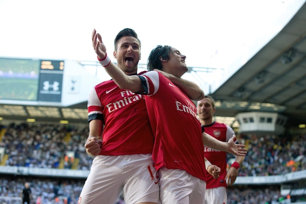 Arsenal's Tomas Rosicky, right, celebrates scoring with teammate Olivier Giroud during the English Premier League soccer match between Tottenham Hotspur and Arsenal at White Hart Lane stadium in London, Sunday, March 16, 2014. (AP Photo/Matt Dunham)