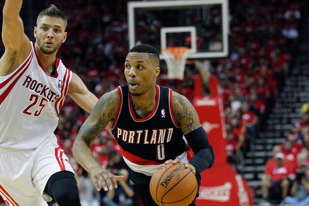 HOUSTON, TX - APRIL 20:  Damian Lillard #0 of the Portland Trail Blazers dribbles around Chandler Parsons #25 of the Houston Rockets in Game One of the Western Conference Quarterfinals during the 2014 NBA Playoffs at the Toyota Center on April 20, 2014 in Houston, Texas. NOTE TO USER: User expressly acknowledges and agrees that, by downloading and or using this photograph, User is consenting to the terms and conditions of the Getty Images License Agreement.  (Photo by Bob Levey/Getty Images)