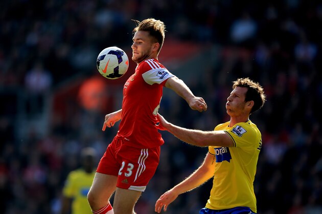 SOUTHAMPTON, ENGLAND - MARCH 29:  Luke Shaw of Southampton controls the ball under pressure from Michael Williamson of Newcastle United during the Barclays Premier League match between Southampton and Newcastle United at St Mary's Stadium on March 29, 2014 in Southampton, England.  (Photo by Richard Heathcote/Getty Images)