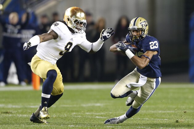 Pittsburgh wide receiver Tyler Boyd (23) runs the ball past Notre Dame linebacker Jaylon Smith (9) in the first quarter of an NCAA college football game Saturday, Nov. 9, 2013, in Pittsburgh. (AP Photo/Keith Srakocic)