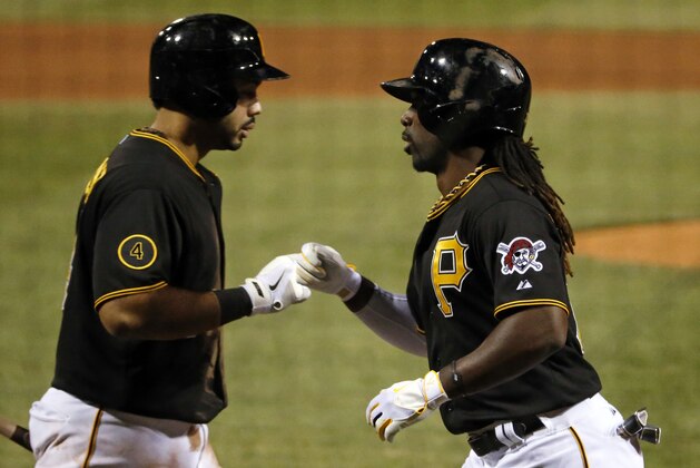 Pittsburgh Pirates' Andrew McCutchen, right, is greeted by teammate Pedro Alvarez as he returns to the dugout after hitting a solo home run off Cincinnati Reds starting pitcher Johnny Cueto during the ninth inning of a baseball game in Pittsburgh Tuesday, April 22, 2014. Cueto 3-hit the Pirates for the second time in a week, and the Reds won 4-1.(AP Photo/Gene J. Puskar)