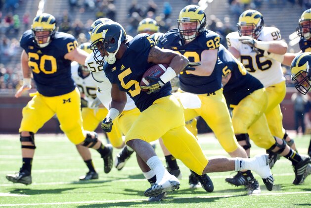 Apr 5, 2014; Ann Arbor, MI, USA; Michigan Wolverines running back Justice Hayes (5) runs with the ball during the Spring Game at Michigan Stadium. Mandatory Credit: Tim Fuller-USA TODAY Sports