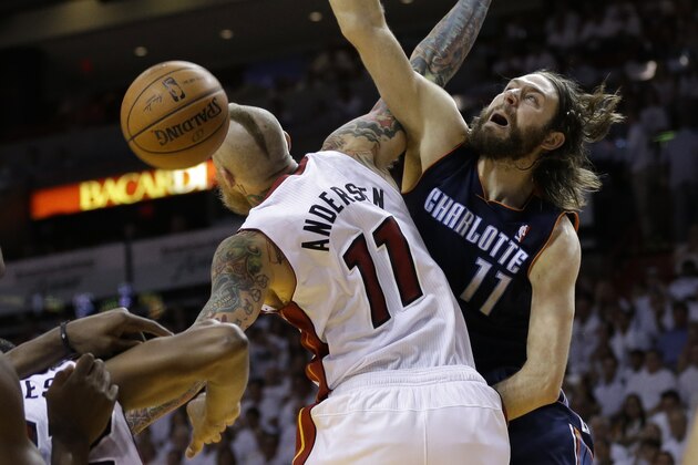 Charlotte Bobcats' Josh McRoberts (11) shoots  over Miami Heat's Chris Andersen (11) during the second half in Game 1 of an opening-round NBA basketball playoff series, Sunday, April 20, 2014, in Miami. The Heat defeated the Bobcats 99-88. (AP Photo/Lynne Sladky)