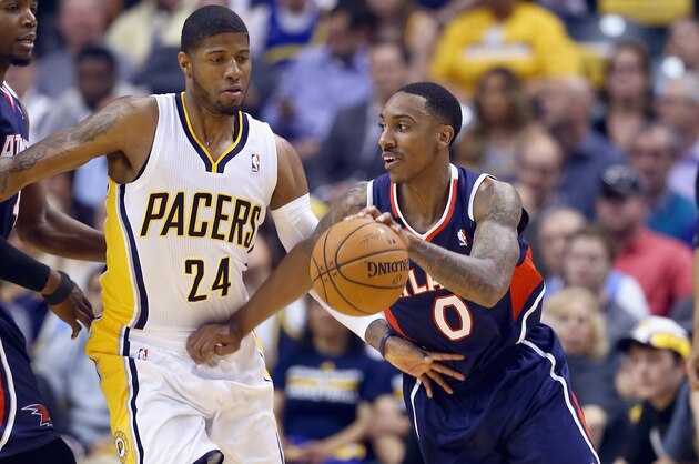 INDIANAPOLIS, IN - APRIL 22:  Paul George #24 of the Indiana Pacers defends Jeff Teague #0 of the Atlanta Hawks in Game 2 of the Eastern Conference Quarterfinals during the 2014 NBA Playoffs at Bankers Life Fieldhouse on April 22, 2014 in Indianapolis, Indiana.   NOTE TO USER: User expressly acknowledges and agrees that, by downloading and or using this photograph, User is consenting to the terms and conditions of the Getty Images License Agreement.  (Photo by Andy Lyons/Getty Images)