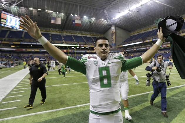Oregon's Marcus Mariota runs toward fans following the Valero Alamo Bowl NCAA college football game against Texas, Monday,  Dec. 30, 2013, in San Antonio. Oregon won 30-7. (AP Photo/Eric Gay)