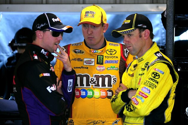 MARTINSVILLE, VA - MARCH 28:  (L-R) Denny Hamlin, driver of the #11 FedEx Freight Toyota, Kyle Busch, driver of the #18 M&M's Toyota, and Matt Kenseth, driver of the #20 Dollar General Toyota, talk in the garage area during practice for the NASCAR Sprint Cup Series STP 500 at Martinsville Speedway on March 28, 2014 in Martinsville, Virginia.  (Photo by Jeff Curry/Getty Images)