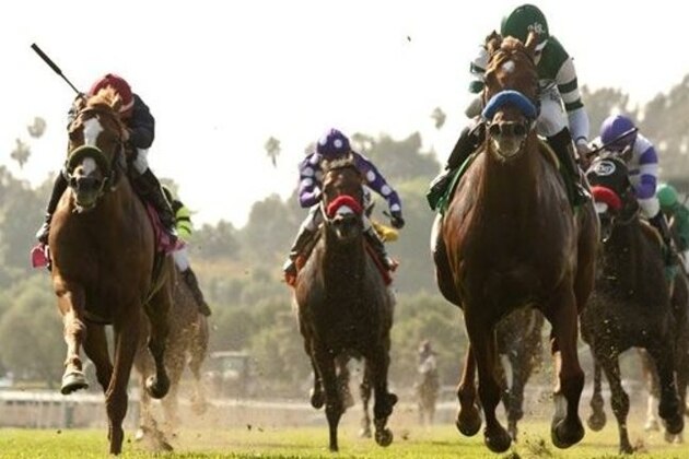 Hronis Racing's Sweet Swap and jockey Joseph Talamo, right, pass Lakerville with jockey Corey Nakatani, left, to win the $100,000 San Simeon Stakes, Sunday, April 13, 2014, at Santa Anita Park, Arcadia Calif. (AP Photo/Benoit Photo)