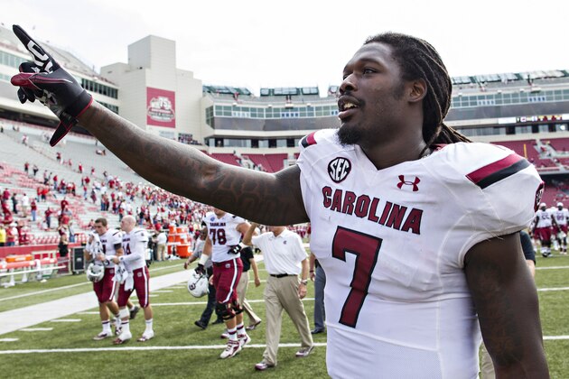 FAYETTEVILLE, AR - OCTOBER 12: Jadeveon Clowney #7 of the South Carolina Gamecocks raises a finger to the fans after a game against the Arkansas Razorbacks at Razorback Stadium on October 12, 2013 in Fayetteville, Arkansas. The Gamecocks defeated the Razorbacks 52-7. (Photo by Wesley Hitt/Getty Images)