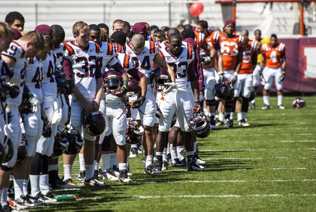 Apr 20, 2013; Blacksburg, VA, USA; The Virginia Tech Hokies observe a moment of silence for the victims of the bombings at the Boston Marathon and the explosion in West, TX before the spring game at Lane Stadium. Mandatory Credit: Peter Casey-USA TODAY Sports