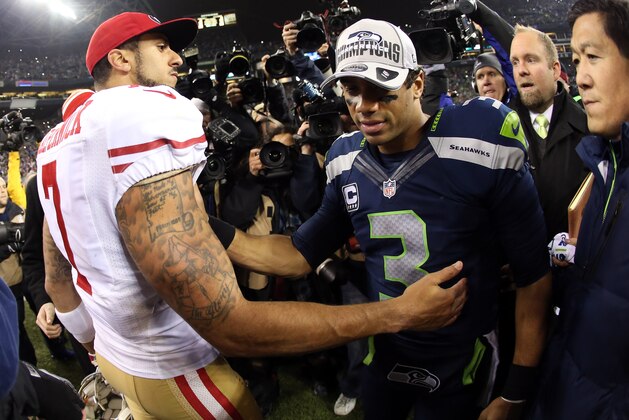 SEATTLE, WA - JANUARY 19:  Quarterback Colin Kaepernick #7 of the San Francisco 49ers shakes hands with quarterback Russell Wilson #3 of the Seattle Seahawks after the Seahawks defeated the 49ers 23-17 during the 2014 NFC Championship at CenturyLink Field on January 19, 2014 in Seattle, Washington.  (Photo by Christian Petersen/Getty Images)