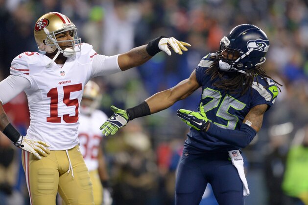 Jan 19, 2014; Seattle, WA, USA; Seattle Seahawks cornerback Richard Sherman (25) is shoved by San Francisco 49ers wide receiver Michael Crabtree (15) while trying to shake hands after an interception by Seahawks outside linebacker Malcolm Smith (not pictured) during the second half of the 2013 NFC Championship football game at CenturyLink Field. The Seahawks defeated the 49ers 23-17 to advance to Super Bowl XLVIII. Mandatory Credit: Kirby Lee-USA TODAY Sports