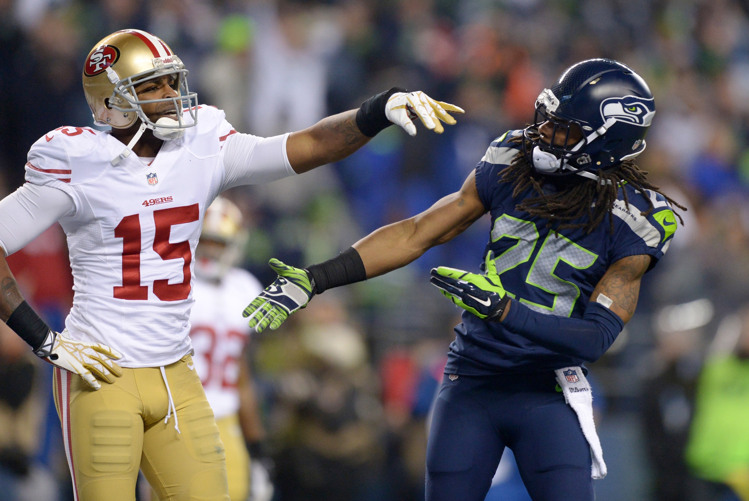 Jan 19, 2014; Seattle, WA, USA; Seattle Seahawks cornerback Richard Sherman (25) is shoved by San Francisco 49ers wide receiver Michael Crabtree (15) while trying to shake hands after an interception by Seahawks outside linebacker Malcolm Smith (not pictured) during the second half of the 2013 NFC Championship football game at CenturyLink Field. The Seahawks defeated the 49ers 23-17 to advance to Super Bowl XLVIII. Mandatory Credit: Kirby Lee-USA TODAY Sports