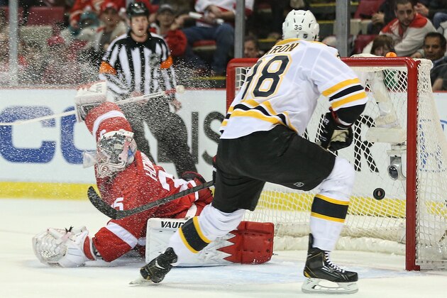 DETROIT, MI - APRIL 22:  Jordan Caron #38 of the Boston Bruins scores a first-period goal on golie Jimmy Howard #35 of the Detroit Red Wings in Game Three of the First Round of the 2014 NHL Stanley Cup Playoffs at Joe Louis Arena on April 22, 2014 in Detroit, Michigan.  (Photo by Leon Halip/Getty Images)