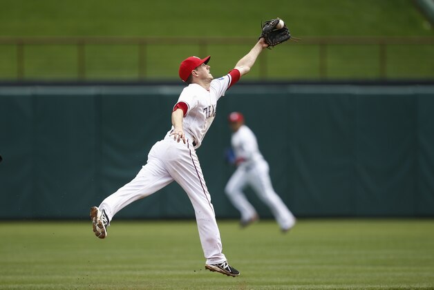 Texas Rangers shortstop Josh Wilson catches a ball hit by Houston Astros' L.J. Hoes for the out during the fifth inning of a baseball game, Sunday, April 13, 2014, in Arlington, Texas. (AP Photo/Jim Cowsert)
