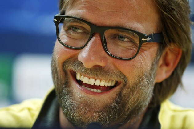Borussia Dortmund's manager Jurgen Klopp laughs during a news conference at Arsenal's Emirates Stadium in London, England, Monday, Oct. 21, 2013. Arsenal are due to play Borussia Dortmund in a Champions League Group F soccer match in London on Tuesday. (AP Photo/Matt Dunham)