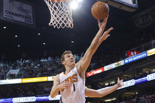 Phoenix Suns' Goran Dragic (1), of Slovenia, drives as Memphis Grizzlies' Marc Gasol, of Spain, defends during the second half of an NBA basketball game, Monday, April 14, 2014, in Phoenix. The Grizzlies won 97-91. (AP Photo/Matt York)