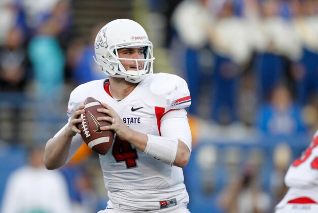 South quarterback Derek Carr (4), of Fresno St., drops back to pass while under pressure from North line backer Michael Sam (55), of Missouri, during the first half of the Senior Bowl NCAA college football game on Saturday, Jan. 25, 2014, in Mobile, Ala. (AP Photo/Butch Dill)