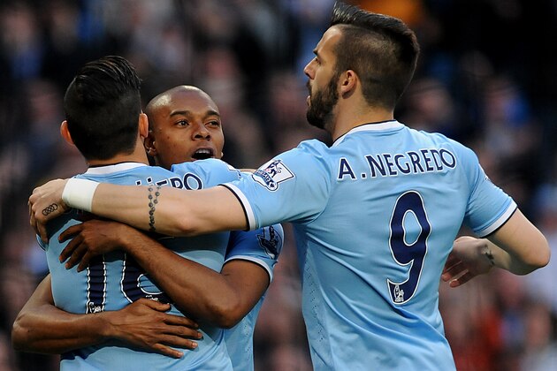 Manchester City's Fernandinho, centre, celebrates with Sergio Aguero, left and Alvaro Negredo after scoring against Sunderland during the English Premier League soccer match between Manchester City and Sunderland at The Etihad Stadium, Manchester, England, Wednesday, April  16, 2014. (AP Photo/Rui Vieira)