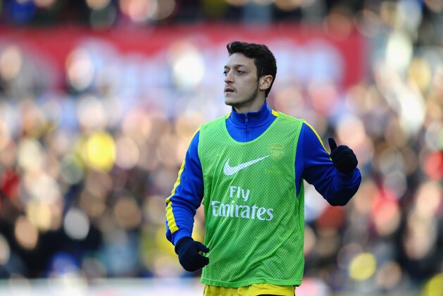 STOKE ON TRENT, ENGLAND - MARCH 01: Mesut Ozil of Arsenal warms up as a substitute  during the Barclays Premier League match between Stoke City and Arsenal at Britannia Stadium on March 1, 2014 in Stoke on Trent, England.  (Photo by Laurence Griffiths/Getty Images)