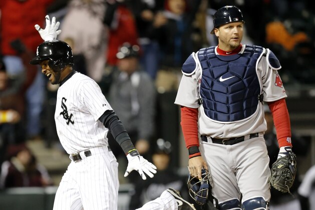 Chicago White Sox's Alexei Ramirez celebrates after scoring the game winning run off a throwing error by Boston Red Sox shortstop Xander Bogaerts as A.J. Pierzynski watches during the ninth inning of a baseball game Tuesday, April 15, 2014, in Chicago. The White Sox won 2-1. (AP Photo/Charles Rex Arbogast)
