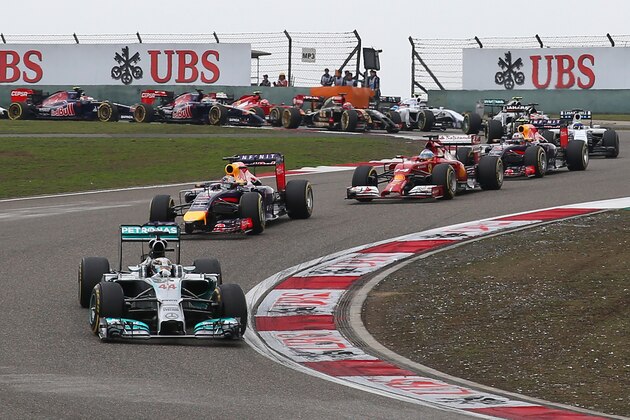 SHANGHAI, CHINA - APRIL 20:  Lewis Hamilton of Great Britain and Mercedes GP leads Sebastian Vettel of Germany and Infiniti Red Bull Racing and Fernando Alonso of Spain and Ferrari into the third corner during the Chinese Formula One Grand Prix at the Shanghai International Circuit on April 20, 2014 in Shanghai, China.  (Photo by Justin Davies/Getty Images)