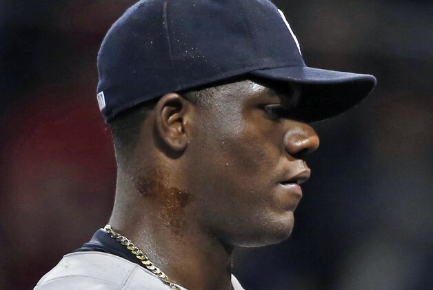 New York Yankees starting pitcher Michael Pineda walks to the dugout after he was ejected when a foreign substance was found on his neck in the second inning of a baseball game against the Boston Red Sox at Fenway Park in Boston, Wednesday, April 23, 2014. (AP Photo/Elise Amendola)