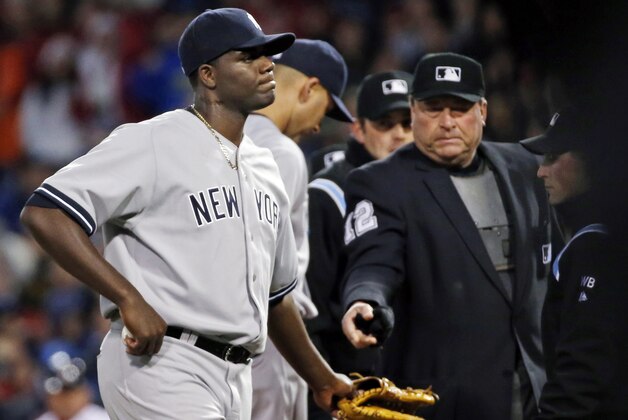 Home plate umpire Gerry Davis ejects New York Yankees starting pitcher Michael Pineda after a foreign substance was discovered on his neck in the second inning of a baseball game against the Boston Red Sox at Fenway Park in Boston, Wednesday, April 23, 2014. (AP Photo/Elise Amendola)