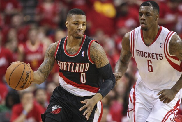 Apr 20, 2014; Houston, TX, USA; Portland Trail Blazers guard Damian Lillard (0) dribbles the ball as Houston Rockets forward Terrence Jones (6) chases during the second quarter of game one during the first round of the 2014 NBA Playoffs at Toyota Center. Mandatory Credit: Troy Taormina-USA TODAY Sports