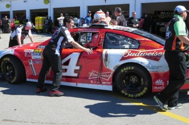 Crew pushes Harvick's No. 4 Chevrolet to inspection.