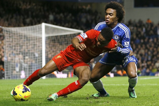 Chelsea's Willian, right, vies for the ball with Liverpool's Raheem Sterling during the English Premier League soccer match between Chelsea and Liverpool at Stamford Bridge Stadium in London, Sunday, Dec. 29, 2013. (AP Photo/Kirsty Wigglesworth)