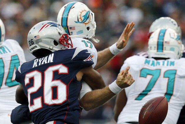 New England Patriots defensive back Logan Ryan, left, strips the ball from Miami Dolphins quarterback Ryan Tannehill (17) in the third quarter of an NFL football game Sunday, Oct. 27, 2013, in Foxborough, Mass. (AP Photo/Michael Dwyer)