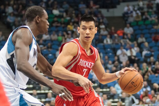 Apr 11, 2014; Minneapolis, MN, USA; Houston Rockets guard Jeremy Lin (7) dribbles against the Minnesota Timberwolves center Gorgui Dieng (5) at Target Center. The Minnesota Timberwolves win 112-110. Mandatory Credit: Brad Rempel-USA TODAY Sports