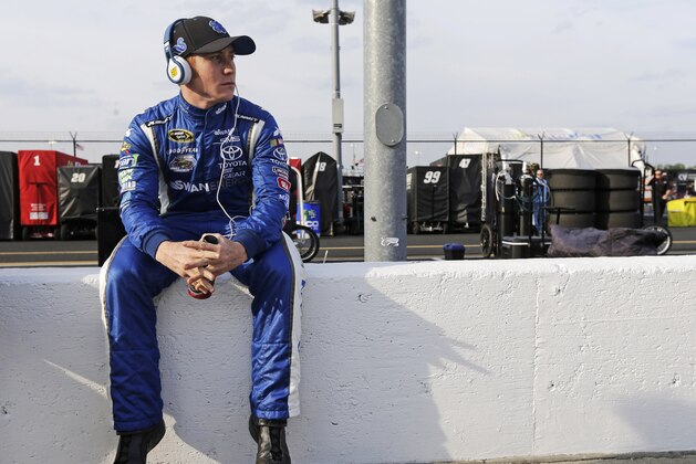 Cole Whitt sits on the pit-road wall as he waits on qualifications for a NASCAR Sprint Cup auto race at Darlington Speedway in Darlington, S.C., Friday, April 11, 2014. (AP Photo/Chuck Burton)