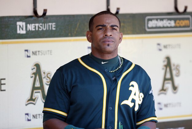Apr 19, 2014; Oakland, CA, USA; Oakland Athletics left fielder Yoenis Cespedes (52) looks out from the Athletics' dugout before the game against the Houston Astros at O.co Coliseum. Mandatory Credit: Bob Stanton-USA TODAY Sports