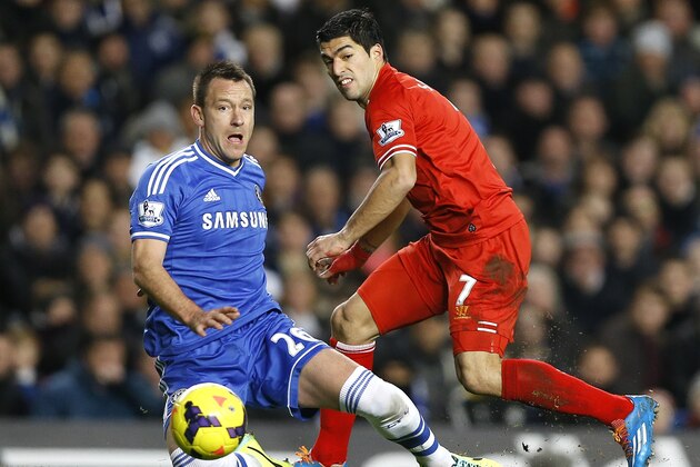 Chelsea's John Terry, left, vies for the ball with Liverpool's Luis Suarez during the English Premier League soccer match between Chelsea and Liverpool at Stamford Bridge Stadium in London, Sunday, Dec. 29, 2013. (AP Photo/Kirsty Wigglesworth)