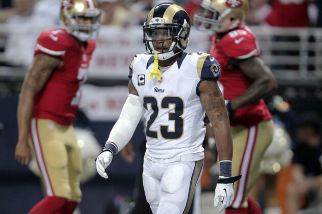 San Francisco 49ers quarterback Colin Kaepernick, left, and tight end Vernon Davis, right, celebrate Davis' 12-yard touchdown catch as St. Louis Rams safety Rodney McLeod walks away during the third quarter of an NFL football game Thursday, Sept. 26, 2013, in St. Louis. (AP Photo/Tom Gannam)