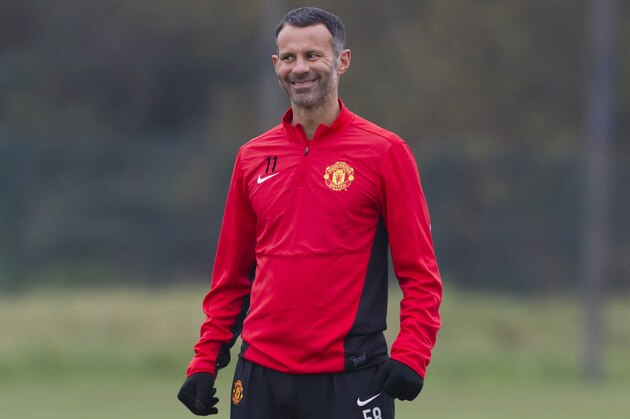Manchester United's Ryan Giggs smiles during a training session at Carrington training ground in Manchester, England, Tuesday Nov. 26, 2013. Manchester United will play Bayer Leverkusen in Germany in a Champion's League Group A soccer match on Wednesday. (AP Photo/Jon Super)