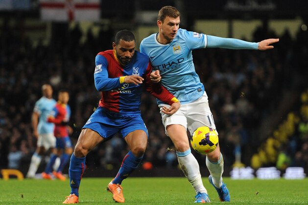 MANCHESTER, ENGLAND - DECEMBER 28:  Jason Puncheon of Crystal Palace competes with Edin Dzeko of Manchester City during the Barclays Premier League match between Manchester City and Crystal Palace at the Etihad Stadium on December 28, 2013 in Manchester, England.  (Photo by Clint Hughes/Getty Images)