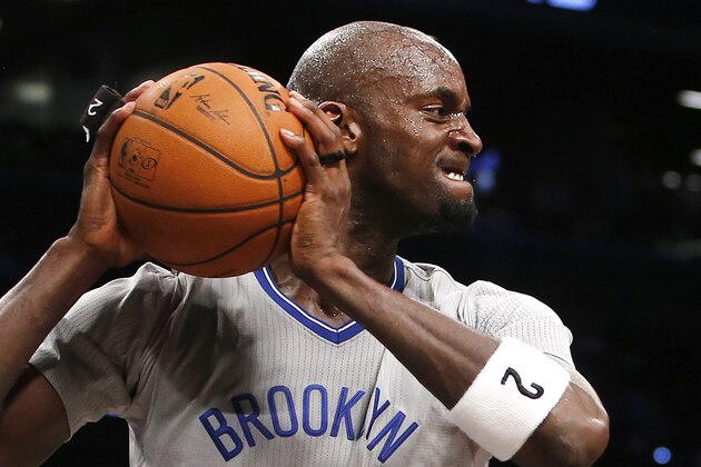 Brooklyn Nets' Kevin Garnett (2) reacts after blocking a shot by Atlanta Hawks' Paul Millsap during the second half of an NBA basketball game Friday, April 11, 2014, in New York.  Atlanta won 93-88. (AP Photo/Jason DeCrow)