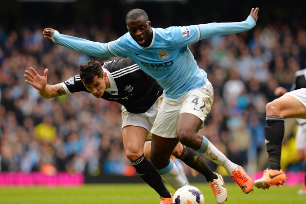 MANCHESTER, ENGLAND - APRIL 05:  Yaya Toure of Manchester City is challenged by Jose Fonte of Southampton during the Barclays Premier League match between Manchester City and Southampton at Etihad Stadium on April 5, 2014 in Manchester, England.  (Photo by Shaun Botterill/Getty Images)