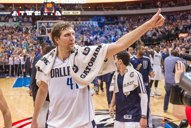 Apr 12, 2014; Dallas, TX, USA; Dallas Mavericks forward Dirk Nowitzki (41) and his team celebrate the win over the Phoenix Suns at the American Airlines Center. The Mavericks defeated the Suns 101-98 and clinched a spot in the NBA playoffs. Mandatory Credit: Jerome Miron-USA TODAY Sports