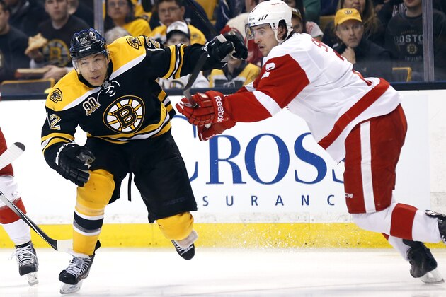 Boston Bruins' Jarome Iginla (12) tries to get past Detroit Red Wings' Brendan Smith during the second period of a first-round NHL playoff hockey game in Boston Friday, April 18, 2014. (AP Photo/Winslow Townson)