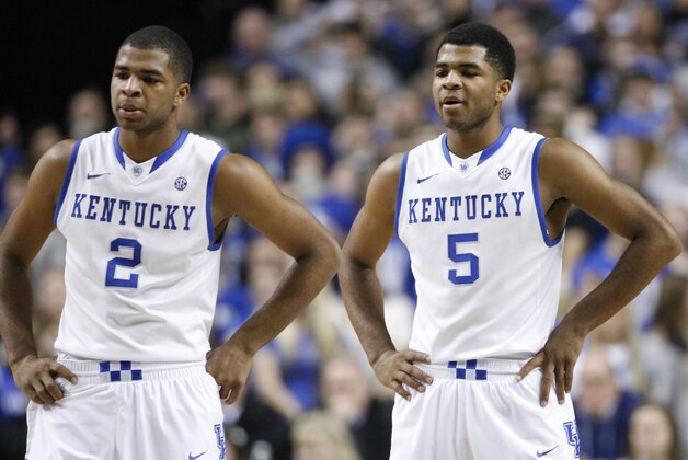 Kentucky's Andrew Harrison (5) and Aaron Harrison (2) talk  during the second half of an NCAA college basketball game against Texas-Arlington, Tuesday, Nov. 19, 2013, in Lexington, Ky. Kentucky won 105-76. (AP Photo/James Crisp)