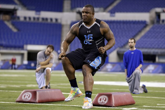Minnesota defensive lineman Ra'Shede Hageman runs a drill at the NFL football scouting combine in Indianapolis, Monday, Feb. 24, 2014. (AP Photo/Michael Conroy)