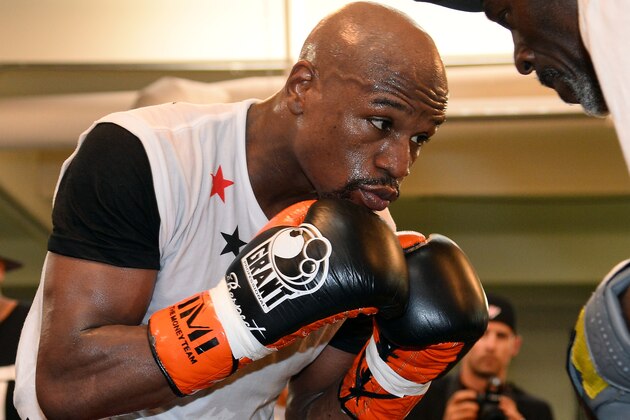 LAS VEGAS, NV - APRIL 22:  Boxer Floyd Mayweather Jr. works out with his trainer and uncle Roger Mayweather at the Mayweather Boxing Club on April 22, 2014 in Las Vegas, Nevada. Mayweather will face Marcos Maidana in a 12-round world championship unification bout in Las Vegas on May 3.  (Photo by Ethan Miller/Getty Images)